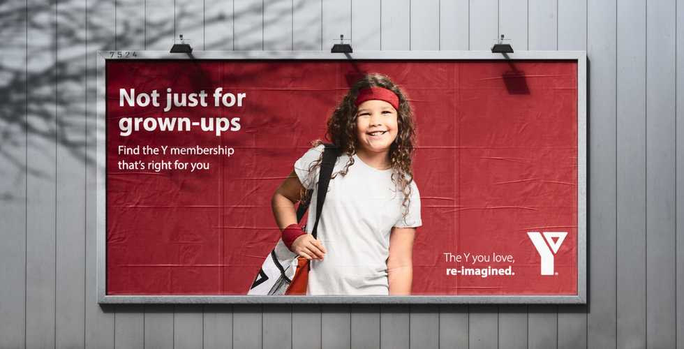 a billboard with a ad for the YMCA with a child on it