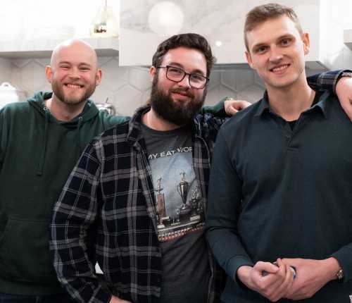 Three male co-worker posing for a photo at a company event